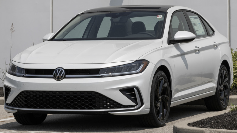 A white Volkswagen Jetta in a parking space.