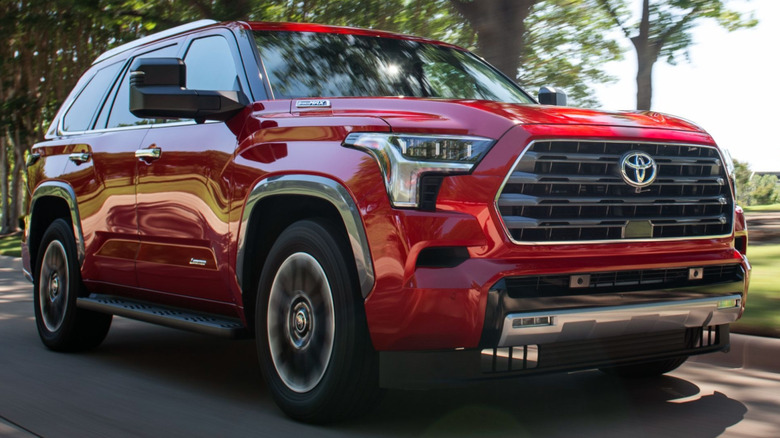 A red Toyota Sequoia driving on a road.