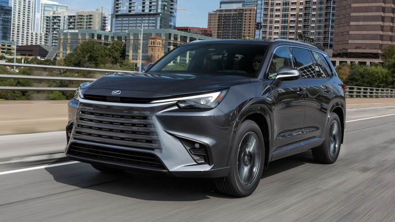 A grey 2026 Lexus TX driving on a city road