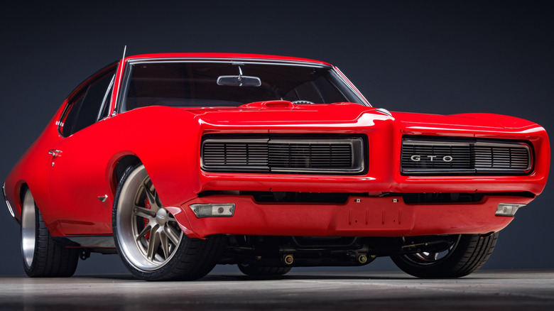 A low front shot of a bright red, rare 1968 Pontiac GTO show car with a hardtop.