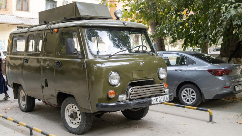 Olive-green UAZ-452 off-road van parked outdoors.