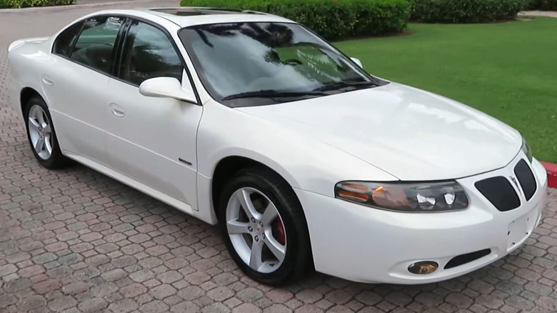 A white 2004–2005 Pontiac Bonneville GXP sedan parked on a paved driveway.