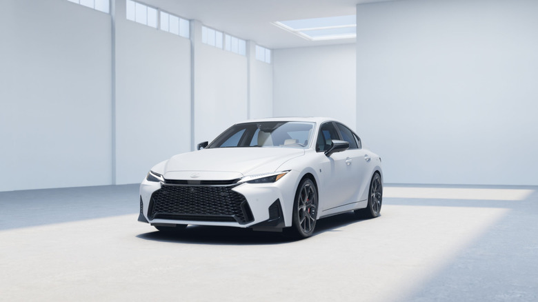 A white 2026 Lexus IS inside an empty, white building