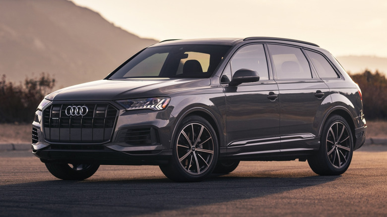 A gray 2021 Audi Q7 parked with a mountain in the background.