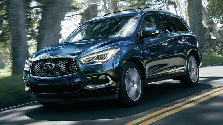A blue 2020 Infiniti QX60 on a two-lane road.