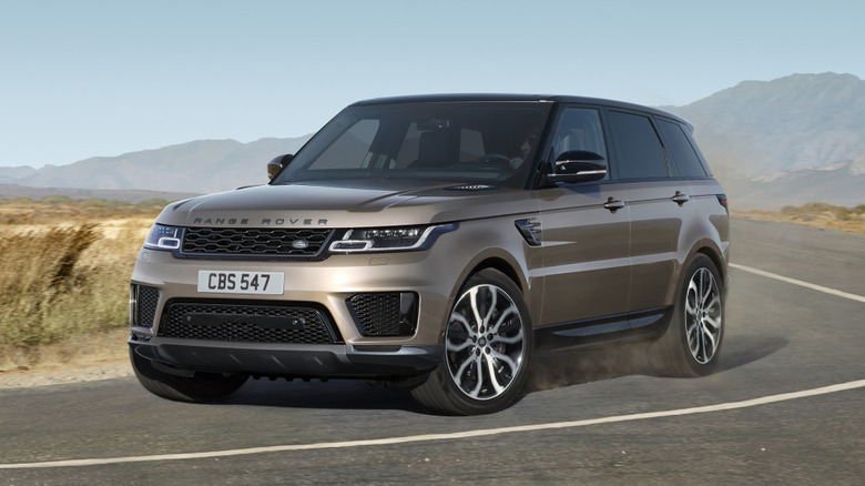 A brown 2021 Land Rover Range Rover Sport on a curved roadway.