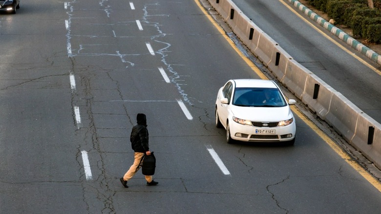 A pedestrian crossing multi-lane highway