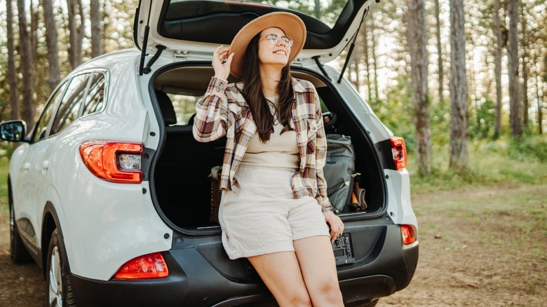 Woman camping with her SUV