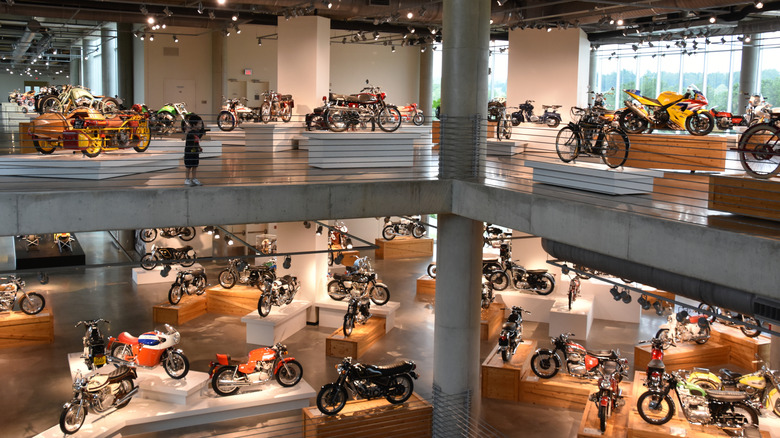 The inside of the Barber Vintage Motorsports Museum, showing multiple display bikes.