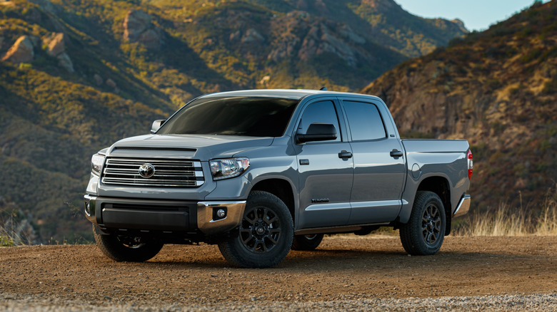A gray 2021 Toyota Tundra parked in front of a mountain range.