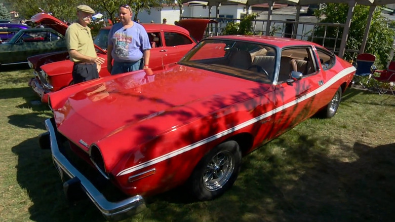 A red 1974 AMC Matador X Coupé with a white stripe across the side.