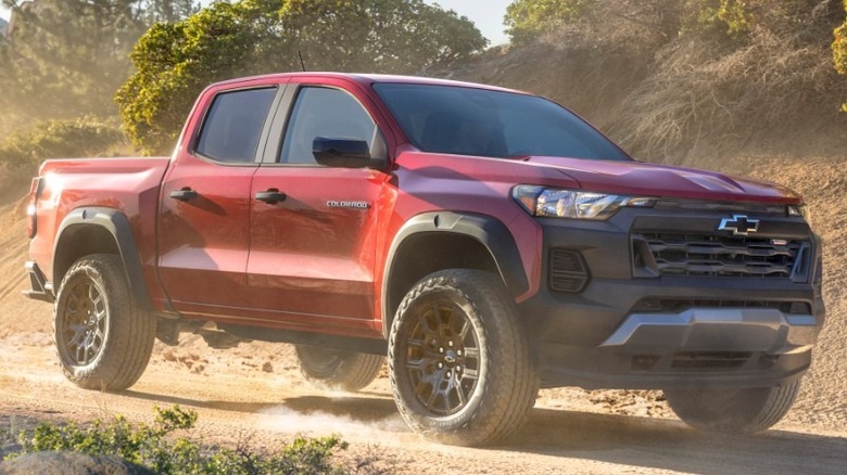 A red 2023 Chevrolet Colorado Trail Boss on a sandy trail