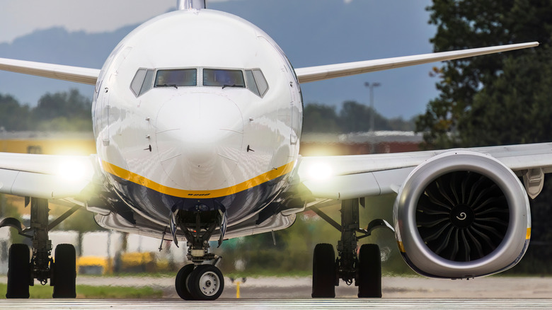 A Boeing 737 MAX taxis across an airport