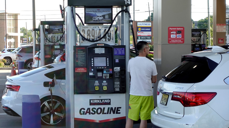 A person gets gas at a Costco fuel center