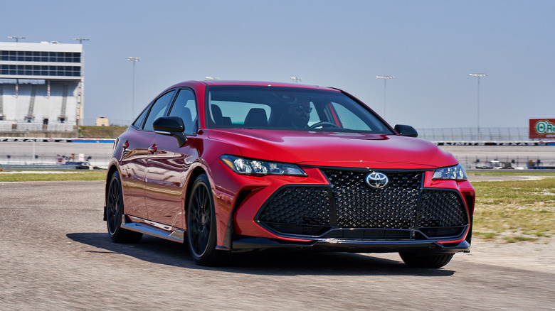 Red 2020 Toyota Avalon sedan right front three-quarter view parked on racetrack