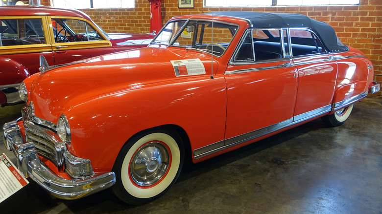 A red 1949 Frazer Manhattan convertible sedan with a black roof at the Zimmerman Automobile Driving Museum in El Segundo, California.