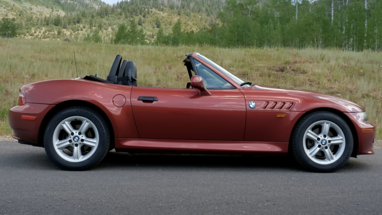 A red BMW Z3 2.5i sits parked in mountains.