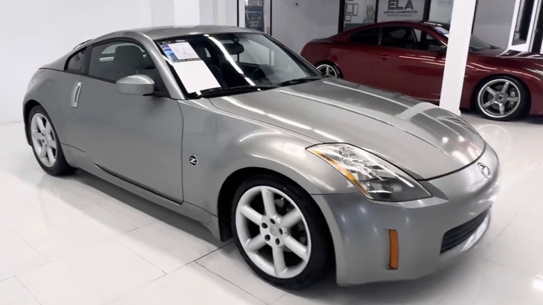 A silver Nissan 350Z Performance sits in a garage.