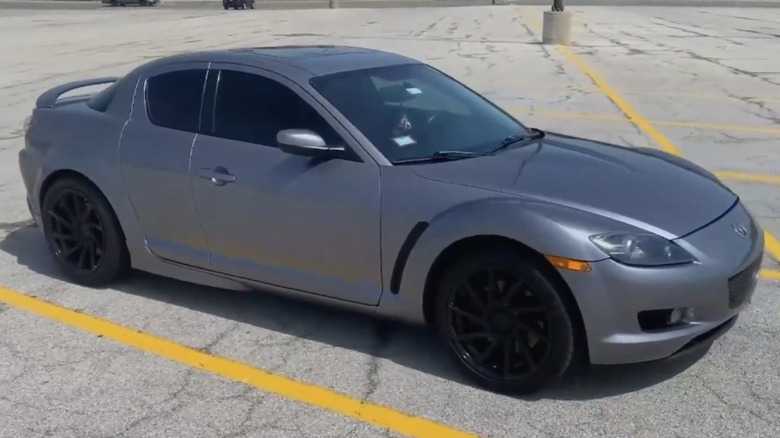 A silver Mazda RX-8 sits parked.