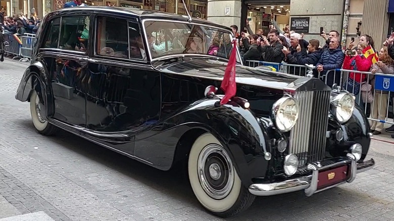 A Rolls-Royce Phantom VI participates in a royal procession.