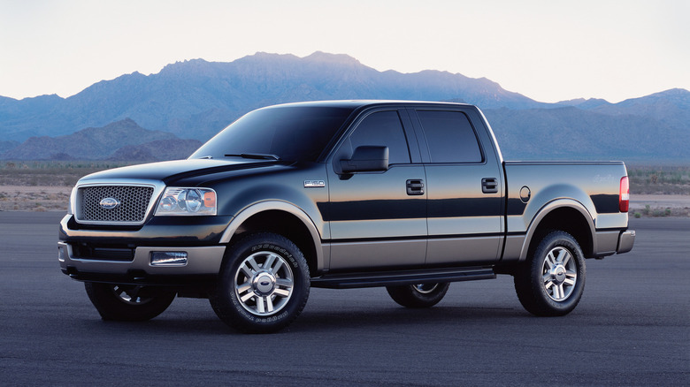 A 2004 Ford F-150 sits parked before mountains.