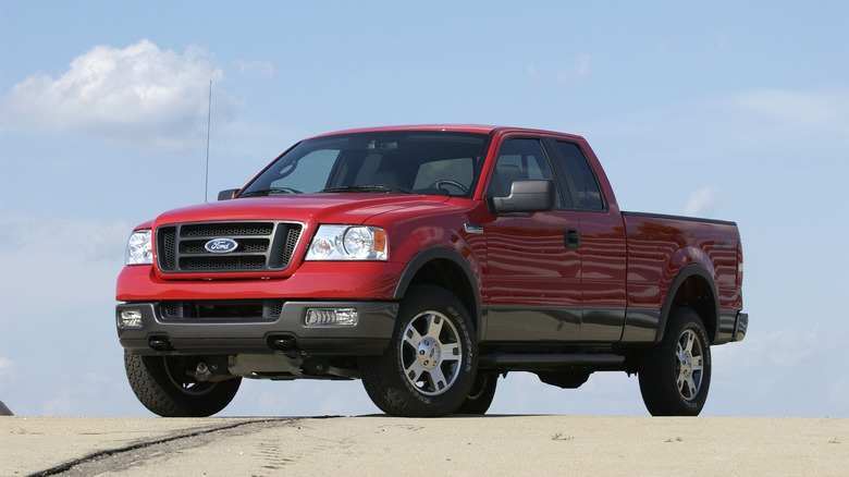 A 2005 Ford F-150 stis parked under a blue sky.