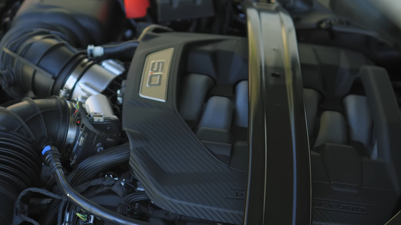 A Ford 5.0 Coyote V8 under the hood of a Mustang Dark Horse pony car