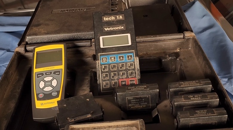 A landscape image of a 1980s/1990s General Motors Tech 1 OBD scan tool.