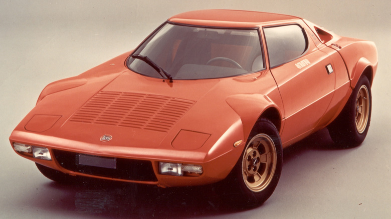 Studio shot of an orange Lancia Stratos.