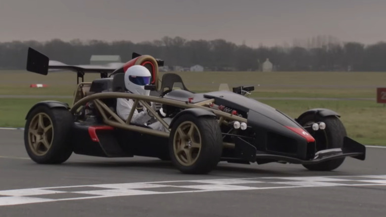 An Ariel Atom 500 V8 track car driven by The Stig across an airfield runway test track