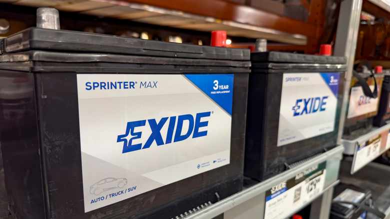 Exide car batteries on display in a store.