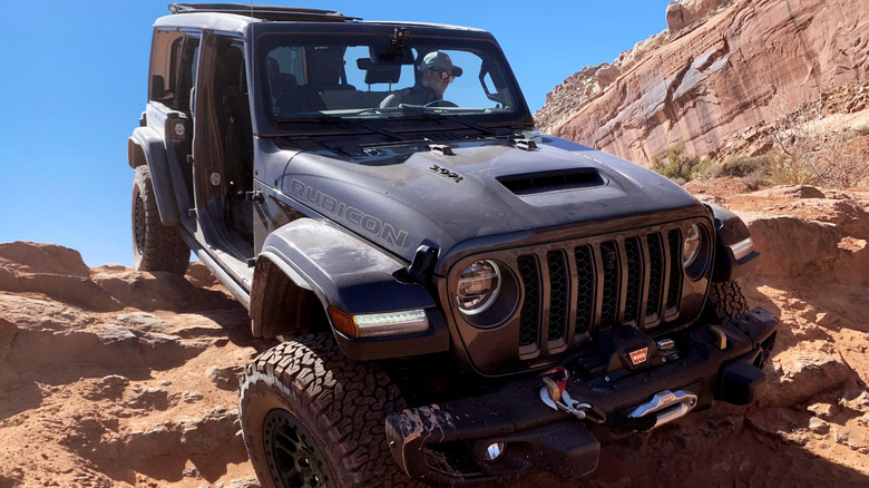 2021 Jeep Wrangler Rubicon 392 SUV front right quarter view rock-crawling off-road in the desert