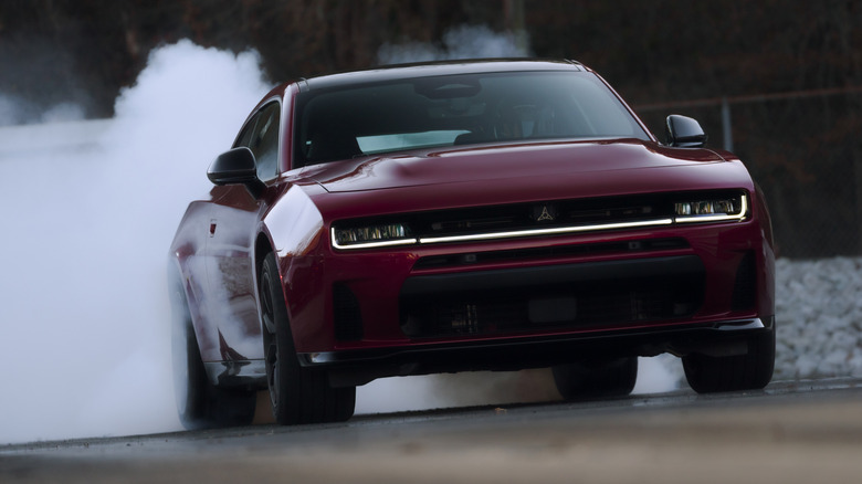 2026 Dodge Charger SIXPACK Scat Pack right front three-quarter view doing a smoking burnout