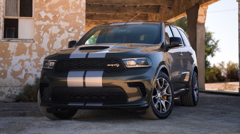 Green 2026 Dodge Durango SRT Hellcat Jailbreak SUV left front three-quarter view parkedin front of an old building