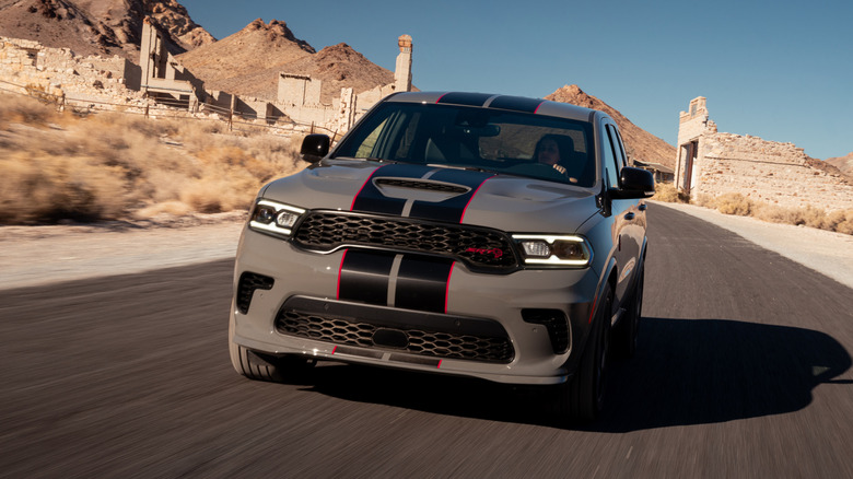 2026 Dodge Durango Hellcat Jailbreak Edition front left view driving on a desert road past ruins