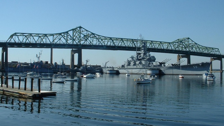 Battleship USS Massachusetts seen from starboard moored in Battleship Cove, Fall River, Massachusetts, with bridge in background