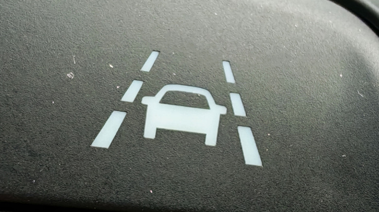 A close-up of a lane keep assist icon shown on a car's dashboard.
