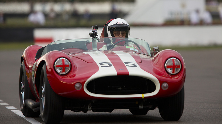 Front view image of a 1958 Devin SS racecar on track.