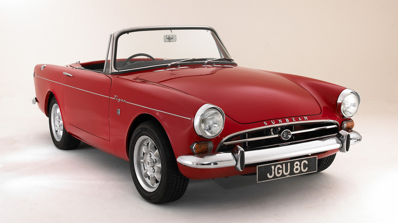 Front three-quarter image of a red 1965 Sunbeam Tiger.