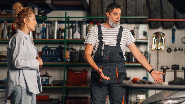 A mechanic is expressive in explaining an automotive issue.