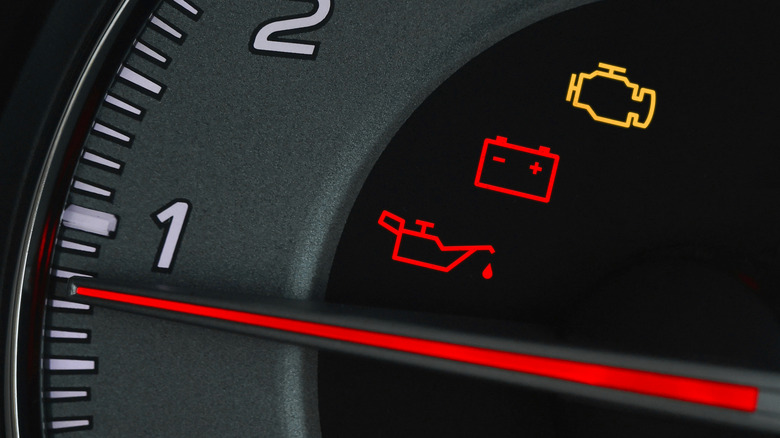 Warning lights glow inside a tachometer.
