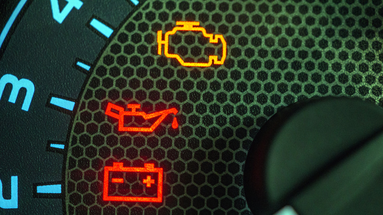 An instrument cluster shows a variety of warning lights.