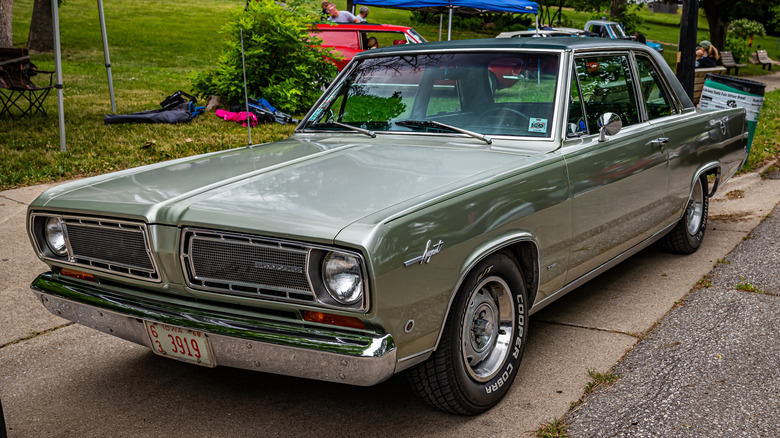 Three-quarter shot of a 1968 Plymouth Valiant at a car show.