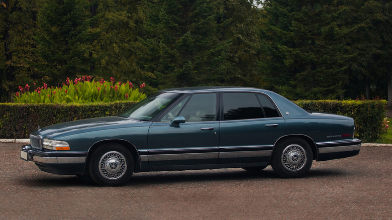 A dark blue Buick Park Avenue pictured from the side parked in, well, a park avenue.