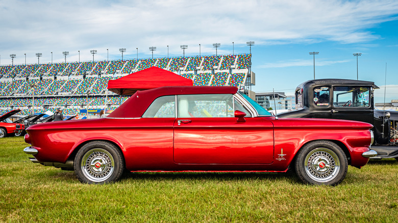 Red Chevy Corvair convertible parked successful nan in-field of a title track