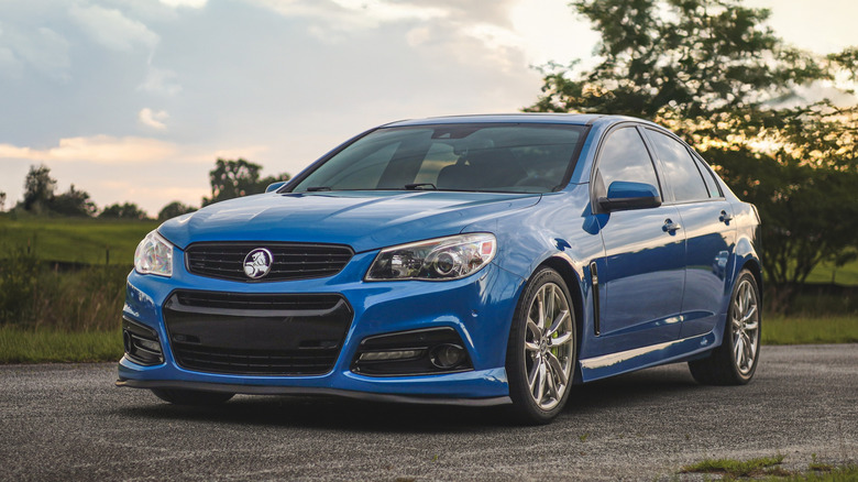 Blue Chevrolet SS sedan pinch Holden badges parked outside
