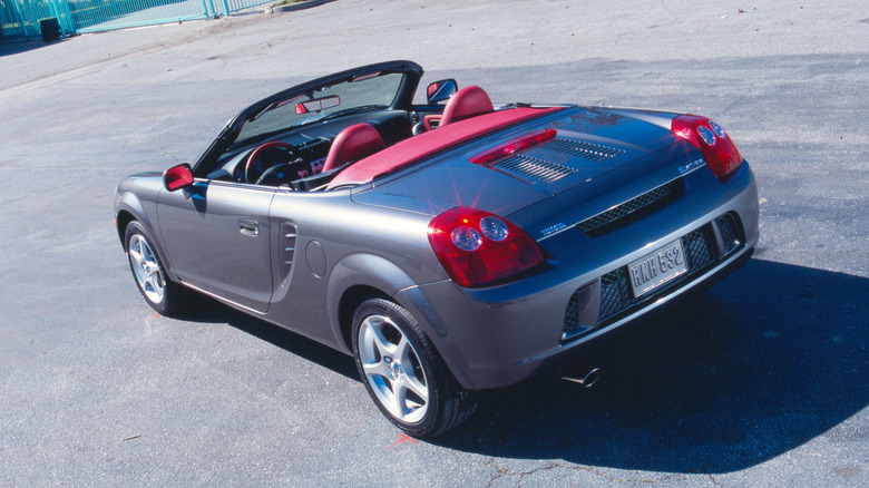 A dark grey 2004 Toyota MR2 Spyder on the road without a driver