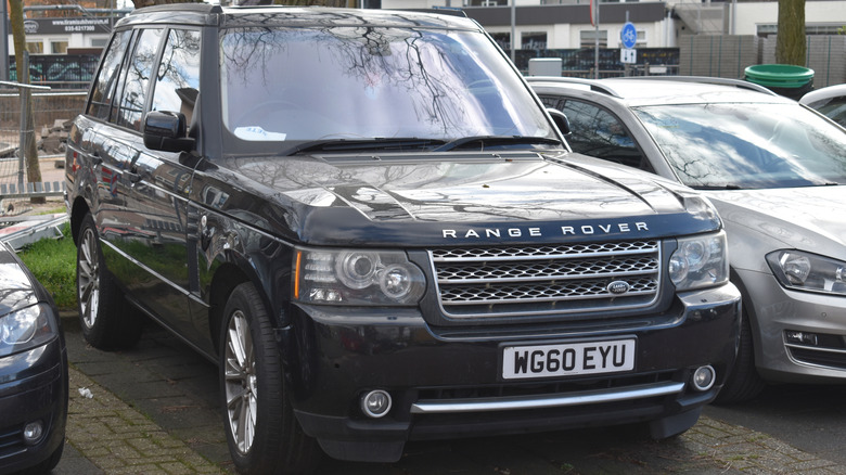 A black Range Rover sits parked.