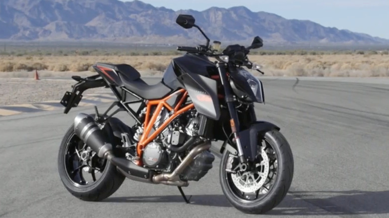 A 2014 KTM 1290 Super Duke R parked at a track.