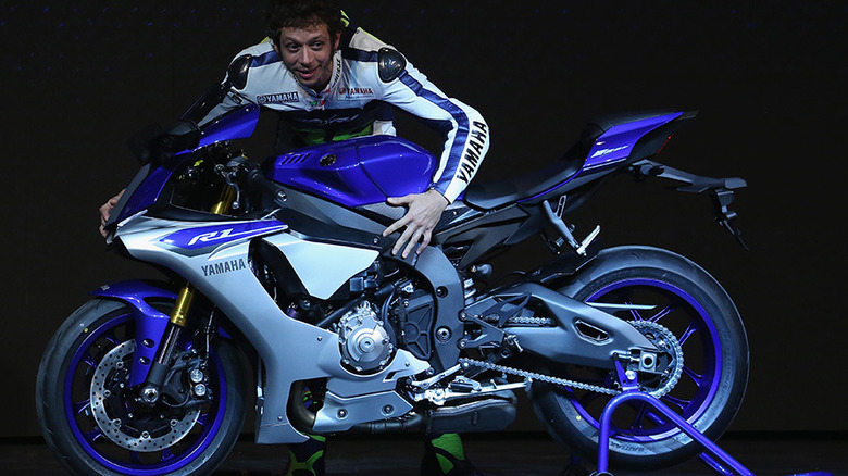 Former motorcycle racer Valentino Rossi with a 2015 Yamaha YZF-R1 on display at its unveiling.